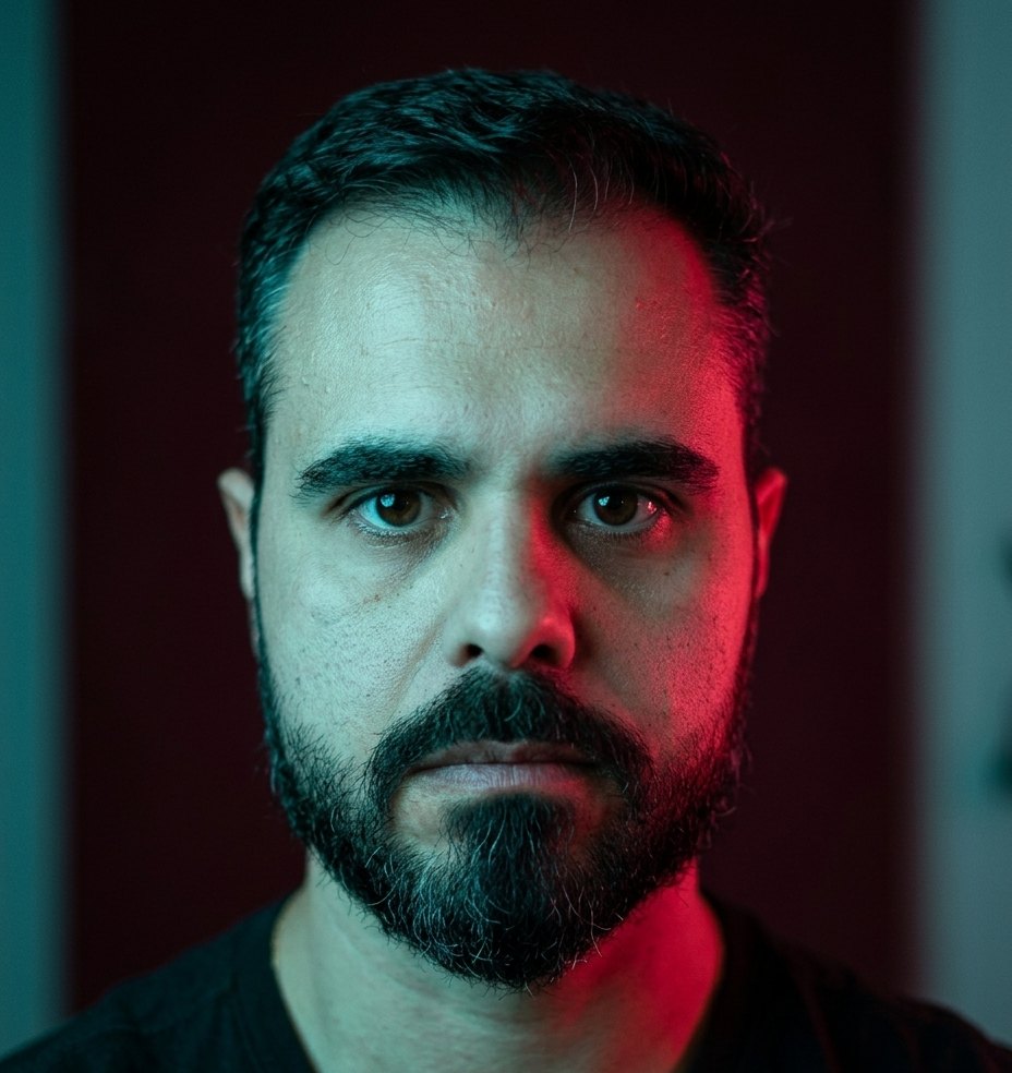 Retrato de Renan Oliveira em luz teal e vermelha